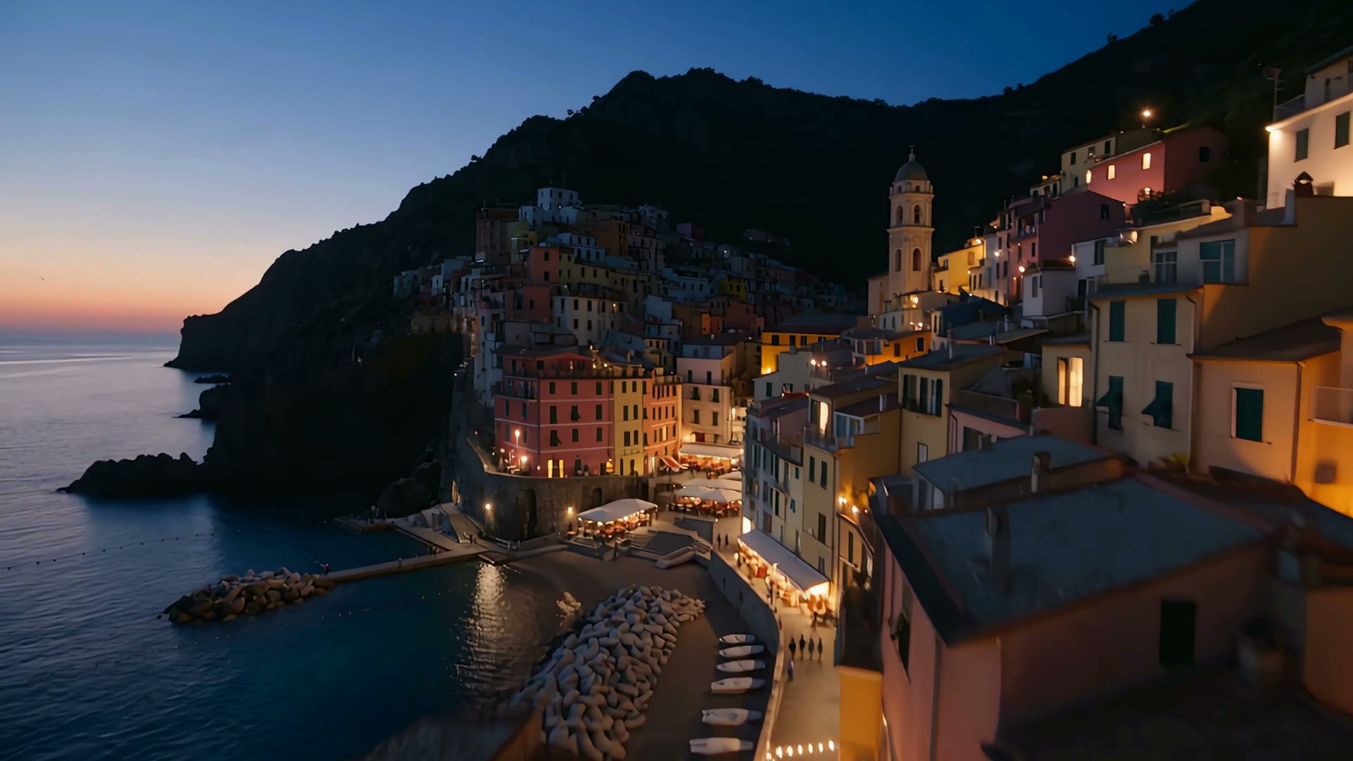 The seaside village at blue hour, every window lit