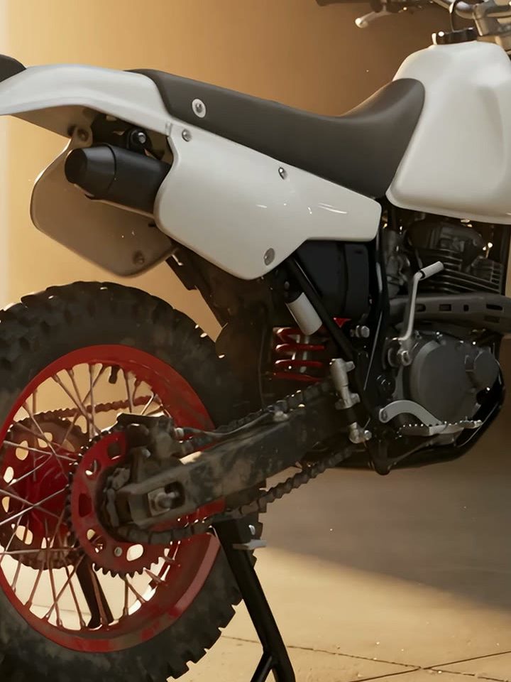 A white nineties enduro bike on its stand in a workshop, backlit