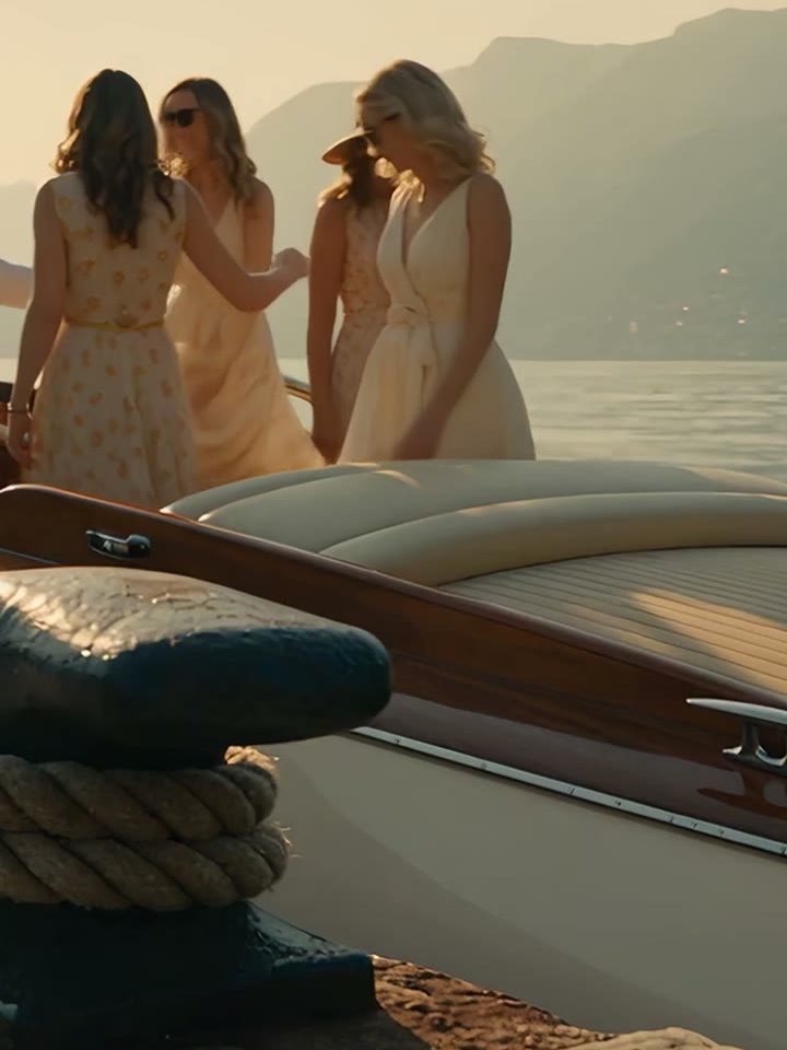 Four friends boarding a wooden motorboat moored at a stone jetty